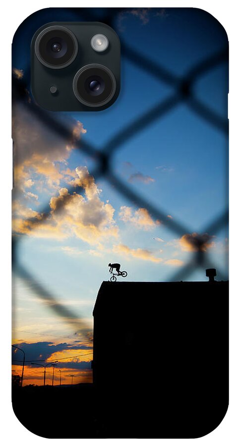 One Person iPhone Case featuring the photograph Cyclo Trial Rider On The Roof Of Old by Adam Kokot