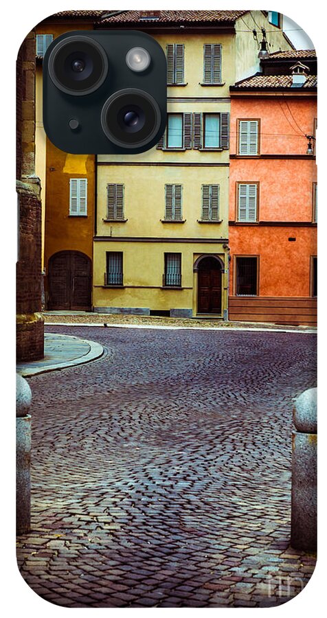 Cobbled iPhone Case featuring the photograph Deserted street with colored houses in Parma Italy by Silvia Ganora