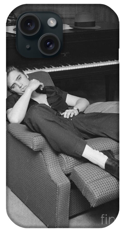 Elvis Presley iPhone Case featuring the photograph Elvis Presley at home by his piano 1956 by The Harrington Collection