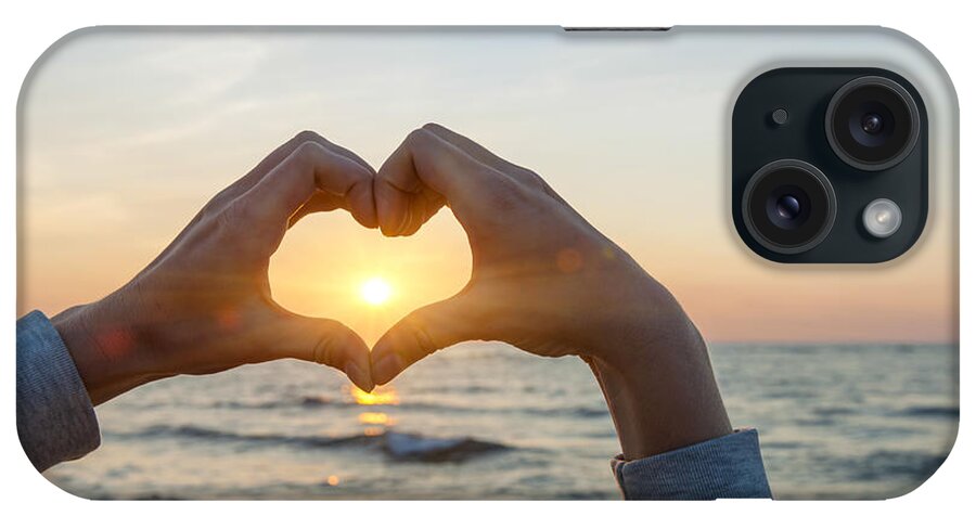 Heart iPhone Case featuring the photograph Fingers heart framing ocean sunset by Elena Elisseeva