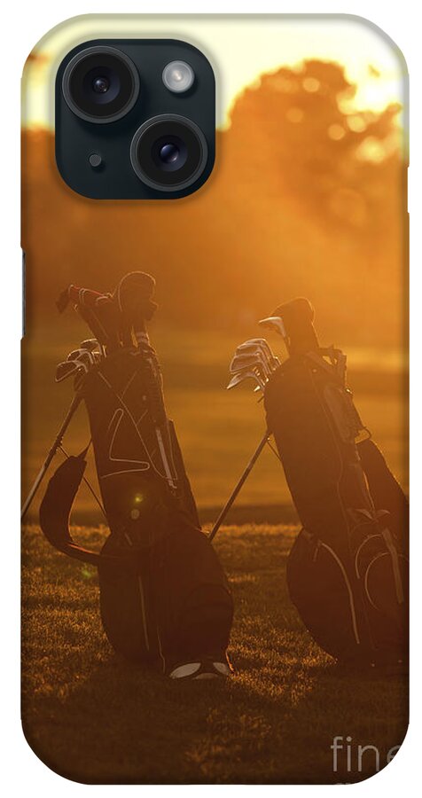 Golf iPhone Case featuring the photograph Golf bags at sunset by Diane Diederich