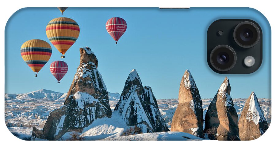 Wind iPhone Case featuring the photograph Hot Air Balloons Over Snow Covered Rock by Izzet Keribar