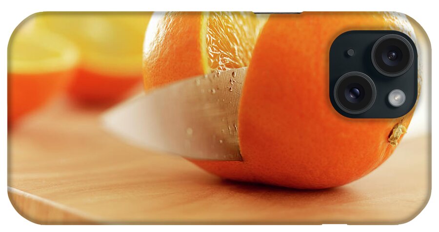 Food And Drink iPhone Case featuring the photograph Knife Slicing Orange On Cutting Board by Adam Gault