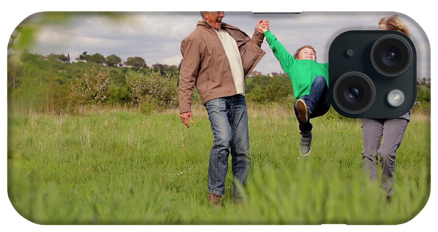 Grass iPhone Case featuring the photograph Mature Couple Swinging Grandchild In by Bloom Productions