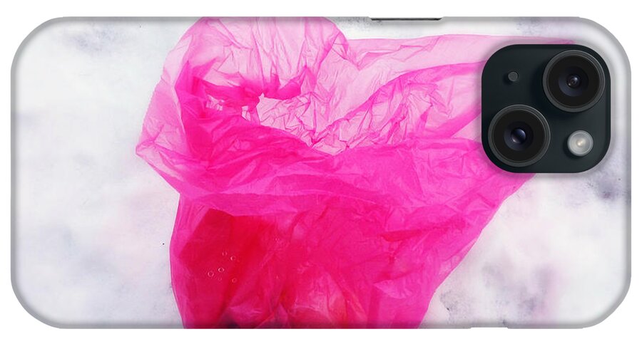 Pink iPhone Case featuring the photograph Pink plastic bag lying on white snow by Matthias Hauser