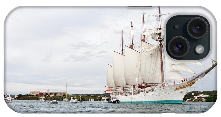 Bay iPhone Case featuring the photograph Juan Sebastian de Elcano famous tall ship of Spanish navy visits Port Mahon in front of bloody islan by Pedro Cardona Llambias