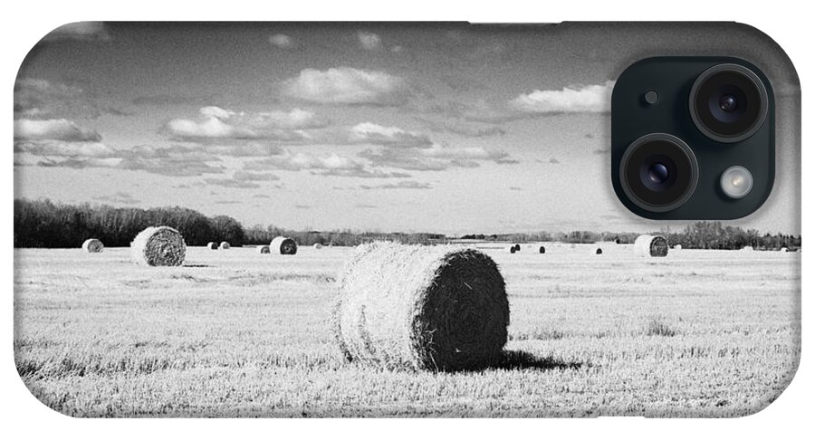 Rolled iPhone Case featuring the photograph rolled hay bales on the prairies after harvest Saskatchewan Canada by Joe Fox