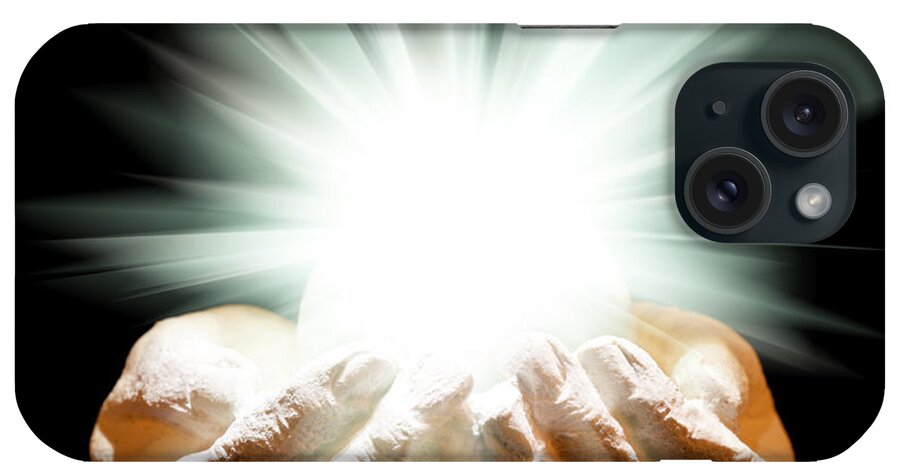 Spiritual iPhone Case featuring the photograph Spiritual light in cupped hands on a black background by Simon Bratt