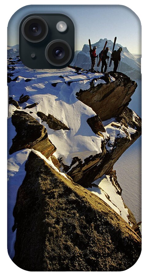 Achievement iPhone Case featuring the photograph Three Skiers Standing On Edge Of Cliff by Whit Richardson