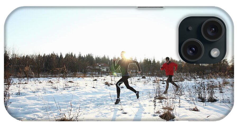 Young Men iPhone Case featuring the photograph Two Runners On Snowy Road In The Morning by Stanislaw Pytel