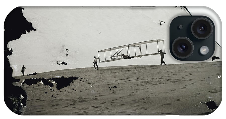 The Wright Brothers iPhone Case featuring the photograph The Wright Brothers Wilbur in motion at left holding one end of glider by Vintage Collectables