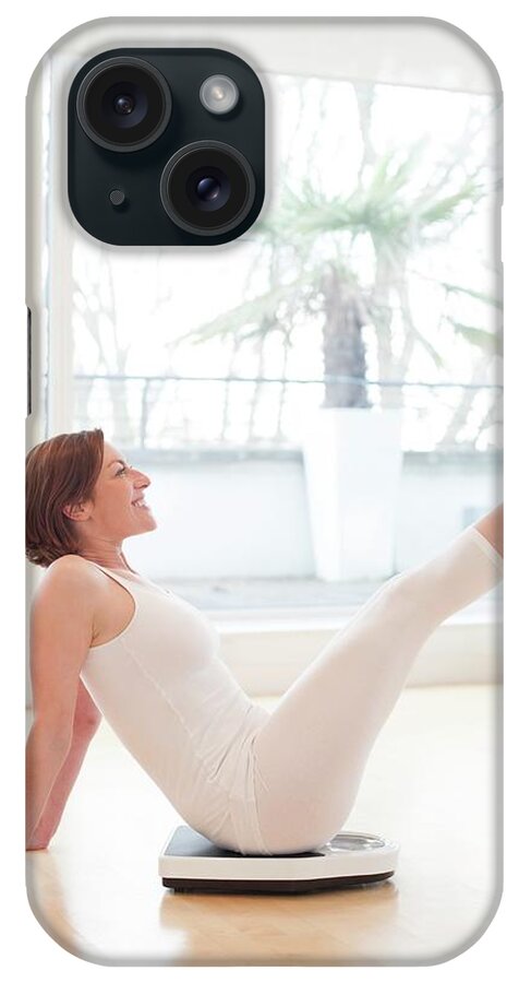 Indoors iPhone Case featuring the photograph Woman On Scales by Ian Hooton
