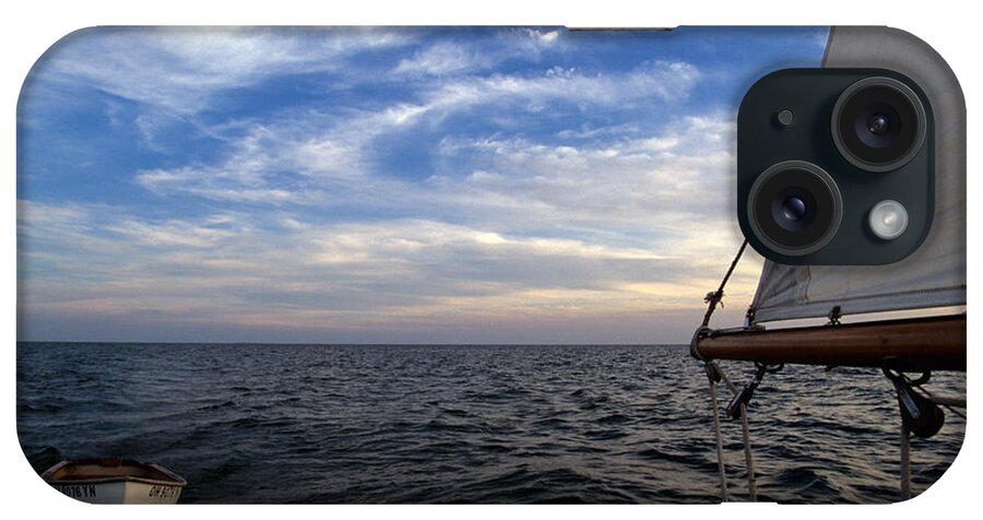 Water iPhone Case featuring the photograph A Connie Dingy follows a Classic Sailboat by John Harmon