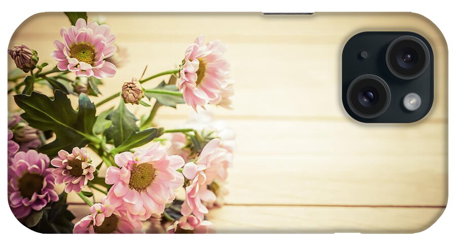 Flowers iPhone Case featuring the photograph Bouquet of fresh spring flowers on rustic wood by Michal Bednarek