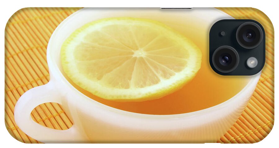 Tea iPhone Case featuring the photograph Cup of tea with lemon in warm golden light by GoodMood Art