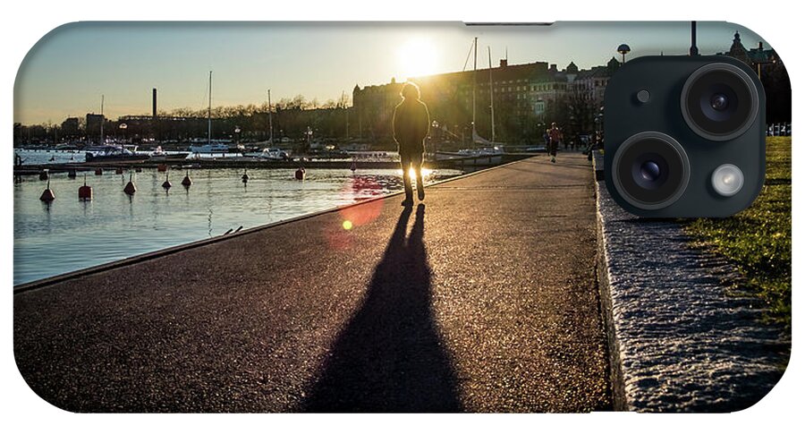 Man Walking At Sunset - Helsinki iPhone Case featuring the photograph Man walking at sunset - Helsinki, Finland - Color street photography by Giuseppe Milo
