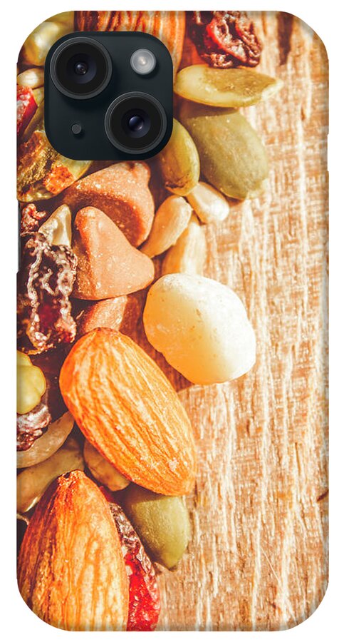 Nuts iPhone Case featuring the photograph Mixed nuts on wooden background by Jorgo Photography