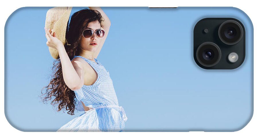 Woman iPhone Case featuring the photograph Pretty girl sitting on a sandy beach by the blue sea. by Michal Bednarek
