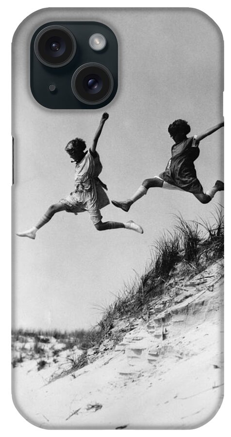 1920s iPhone Case featuring the photograph Two Girls Leaping Off Sand Dune by H Armstrong Roberts and ClassicStock