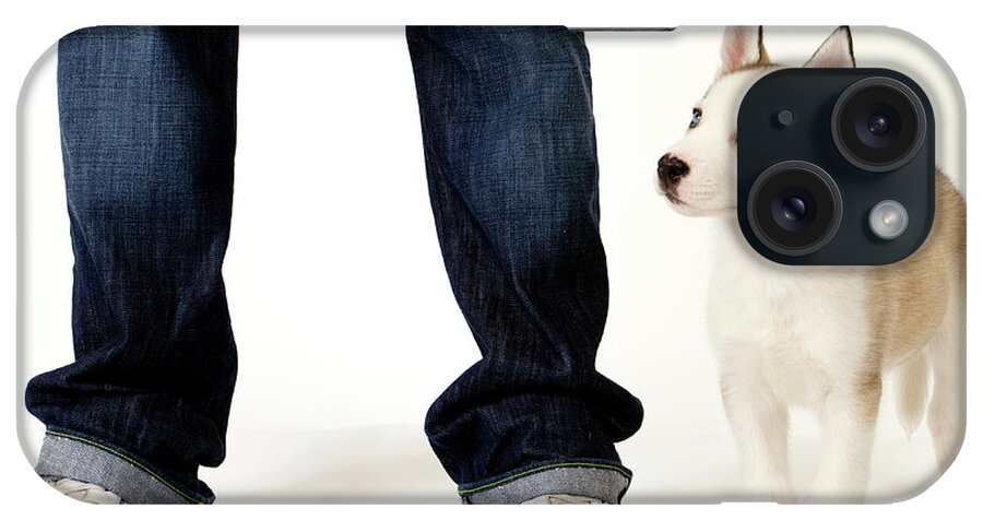 Husky iPhone Case featuring the photograph Cute husky puppy and his master on white #1 by Seeables Visual Arts