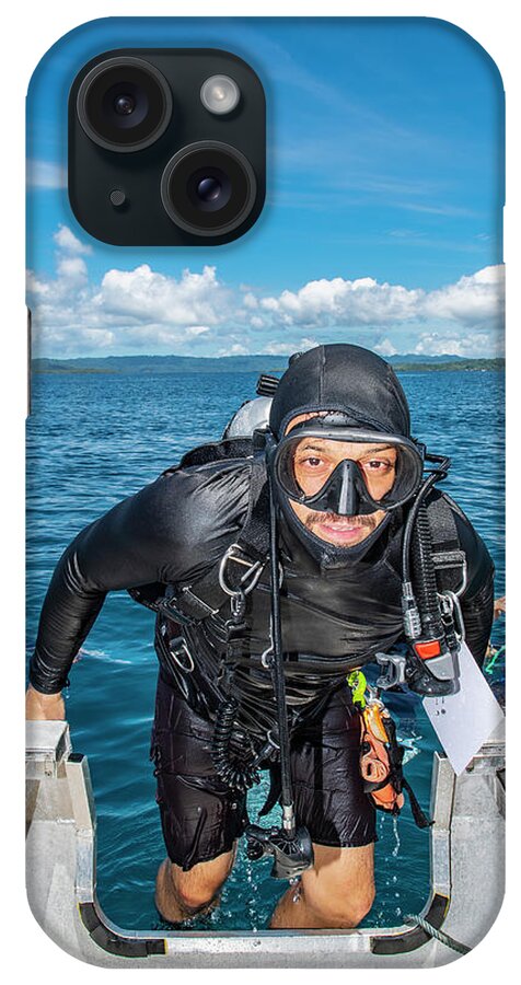 Emerging iPhone Case featuring the photograph Diver Climbing Back Into Dingy After A Successful Dive In Raja Ampat #2 by Cavan Images