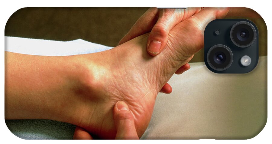 Reflexology iPhone Case featuring the photograph Hands Of A Reflexologist Massaging A Woman's Foot #2 by Faye Norman/science Photo Library