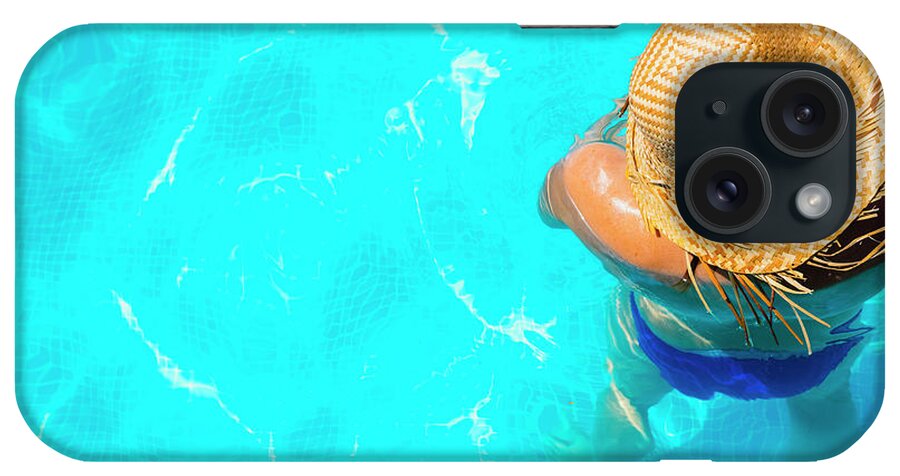 Beautiful iPhone Case featuring the photograph Woman in a pool with hat relaxed and rested. #4 by Joaquin Corbalan