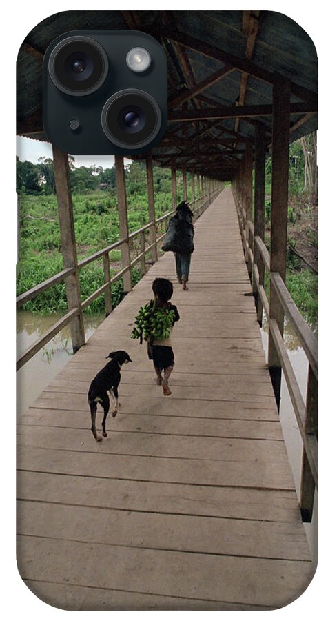 Dog Follows Boy Carrying Bananas In Small Community Outside Iquitos iPhone Case featuring the photograph 753-79 by Robert Harding Picture Library