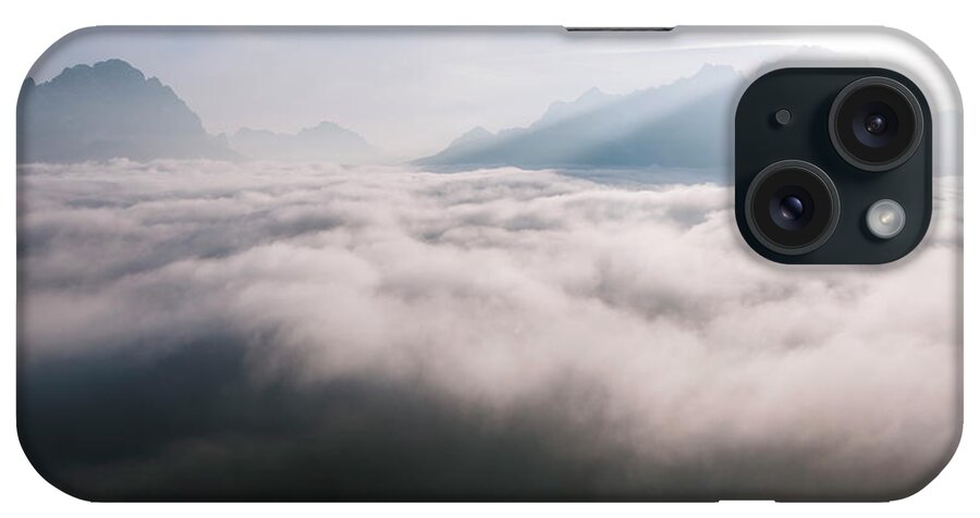Above iPhone Case featuring the photograph Aerial view of low clouds and mountain peak at sunrise by Matteo Colombo
