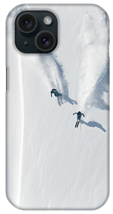 Crash Helmet iPhone Case featuring the photograph Aerial View Of Two Skiers Skiing by Creativaimage