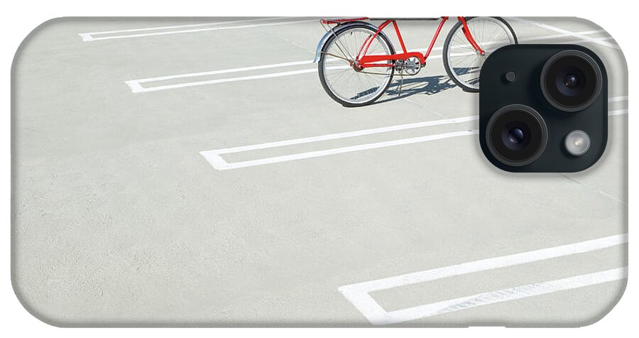 Out Of Context iPhone Case featuring the photograph Bike In Empty Parking Lot by Peter Starman