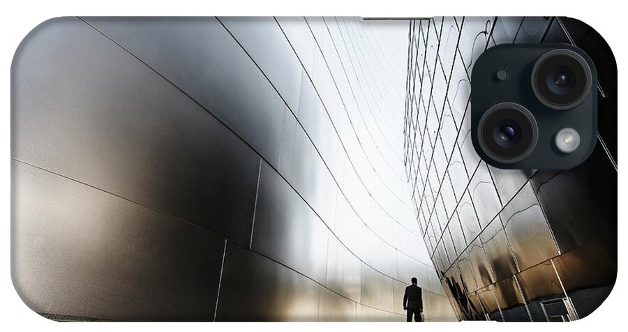 Curve iPhone Case featuring the photograph Businessman Walking In Urban Alley by Blend Images - Peathegee Inc