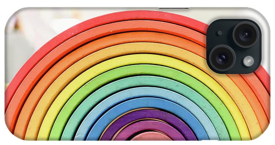 Arrangement iPhone Case featuring the photograph Colorful Waldorf wooden rainbow in a montessori teaching pedagogy classroom. by Joaquin Corbalan