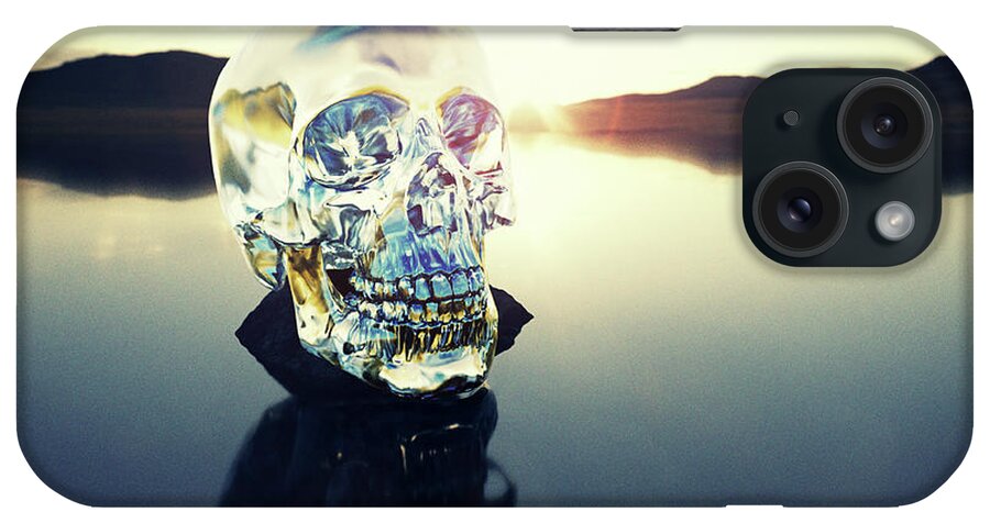 Art iPhone Case featuring the photograph Crystal Skull Laying On Rock In Lake by Doug Armand