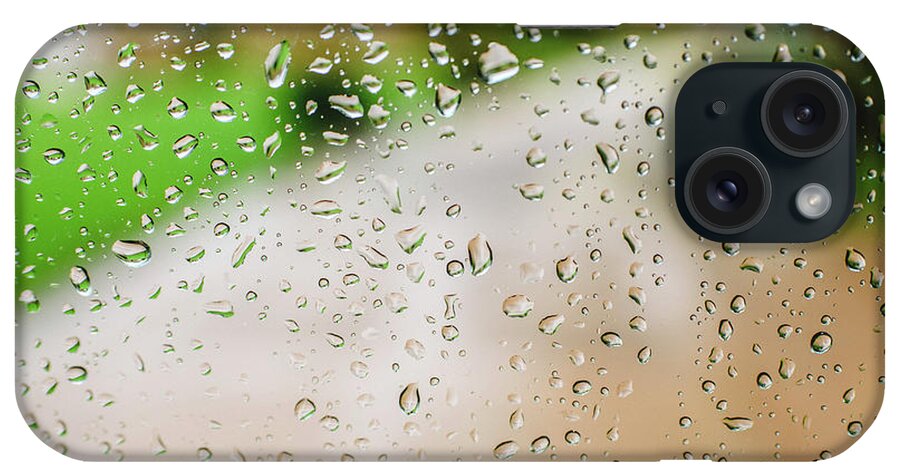 Alone iPhone Case featuring the photograph Drops of rain on an autumn day on a glass. by Joaquin Corbalan