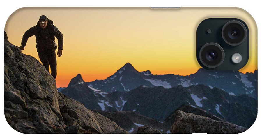 Backpacking iPhone Case featuring the photograph Hiker Navigates A Mountain Route Using Headlamp After Sunset. by Cavan Images
