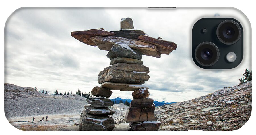 Inukshuk iPhone Case featuring the photograph Inukshuk Standing Tall In A Mountain Setting. by Cavan Images