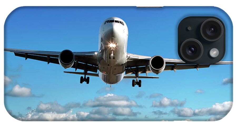 Freight Transportation iPhone Case featuring the photograph Jet Airplane Landing In Cloudy Sky by Sharply done
