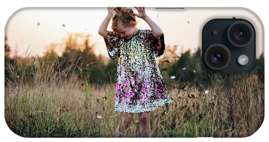Girl iPhone Case featuring the photograph Little Girl Dancing In A Sparkly Dress With Star Confetti Falling by Cavan Images