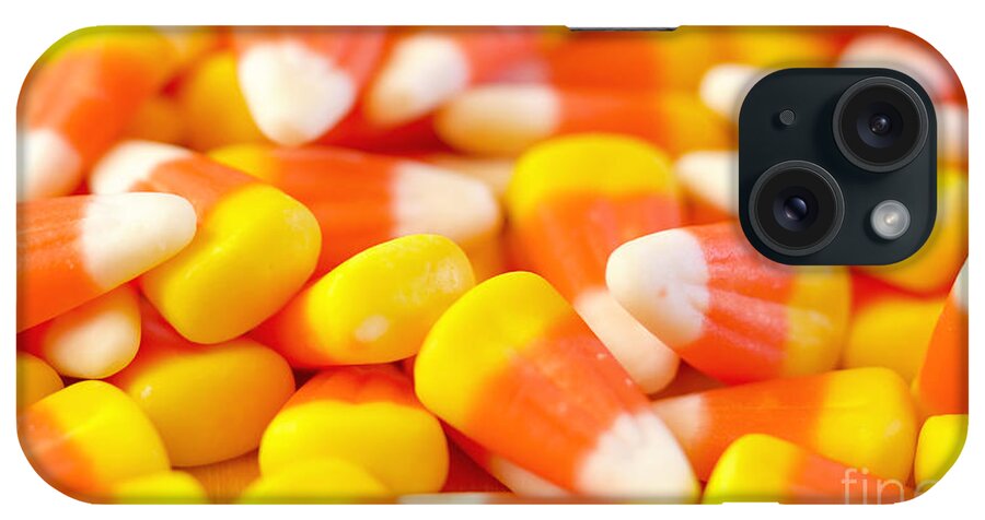 Halloween iPhone Case featuring the photograph Macro closeup of Halloween traditional Candy Corn treats. by Milleflore Images
