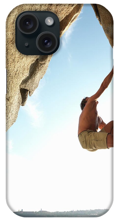 Mature Adult iPhone Case featuring the photograph Mature Man Rock Climbing Above Lake by Ascent/pks Media Inc.