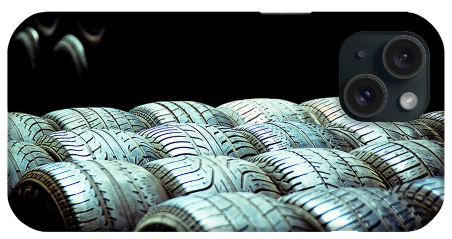 Abandoned iPhone Case featuring the photograph Old tires and racing wheels stacked in the sun by Joaquin Corbalan