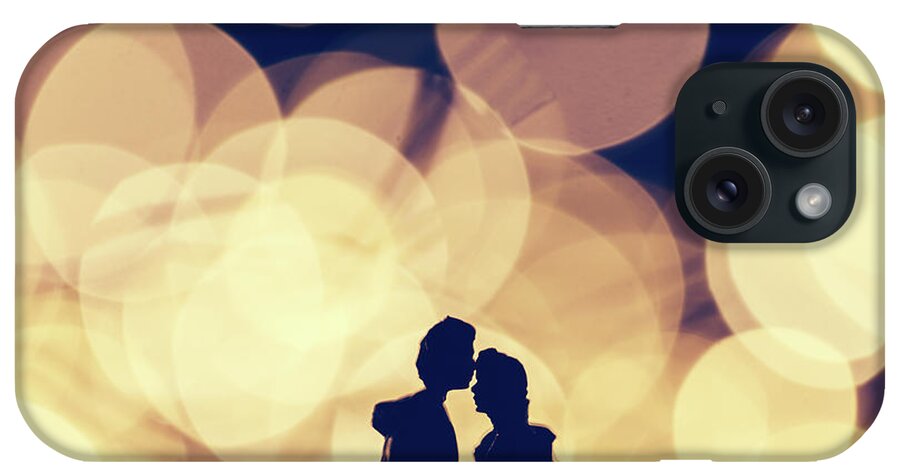 Man iPhone Case featuring the photograph Romantic couple kissing on illuminated background. by Michal Bednarek