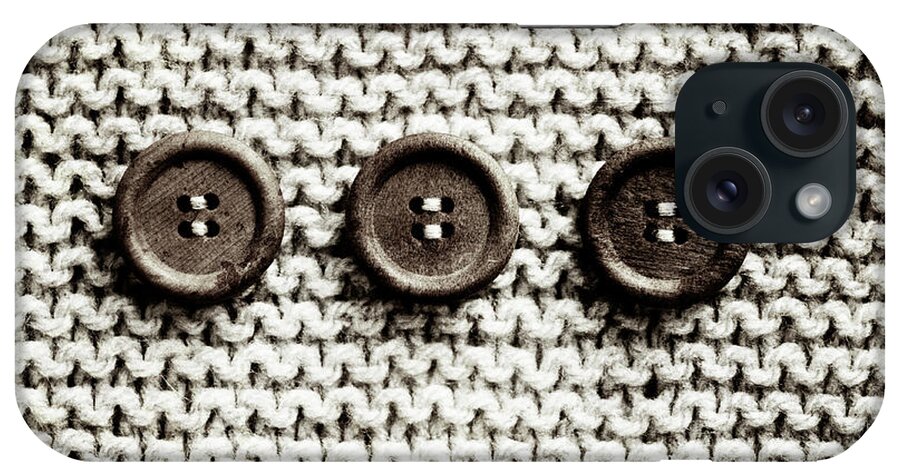 Row Of 3 Old Buttons On Wool iPhone Case featuring the photograph Row Of 3 Old Buttons On Wool by Tom Quartermaine