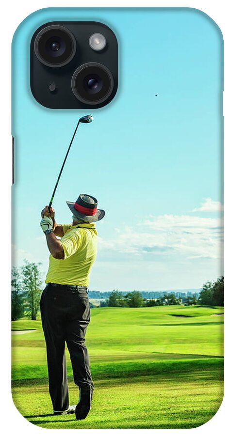 Expertise iPhone Case featuring the photograph Senior Golfer On Golf Course Teeing Off by Jhorrocks