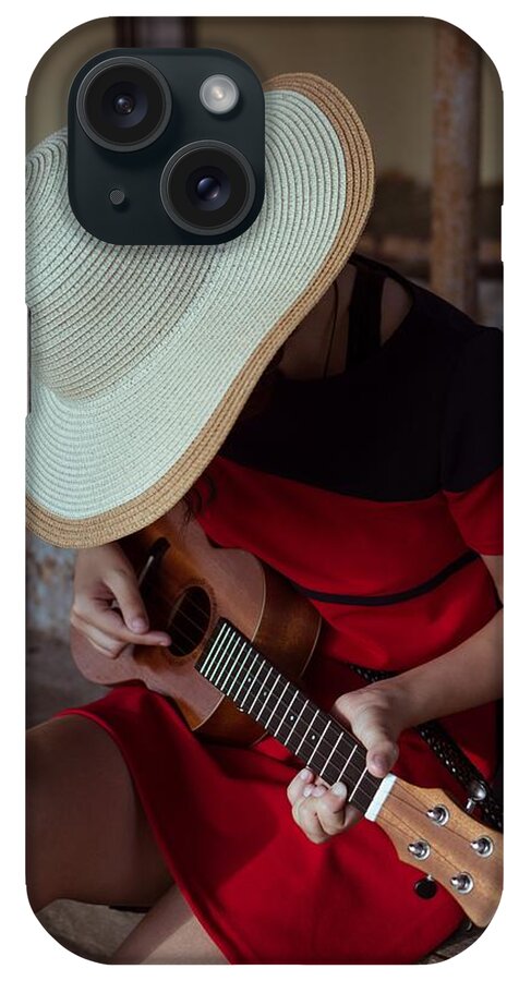 Play Guitar iPhone Case featuring the photograph Side View Of Sitting Girl In Hat, Playing Ukulele, On Old Steps by Cavan Images