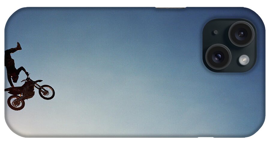 Crash Helmet iPhone Case featuring the photograph Silhouette Of Man Performing Stunts On by Andy Ryan