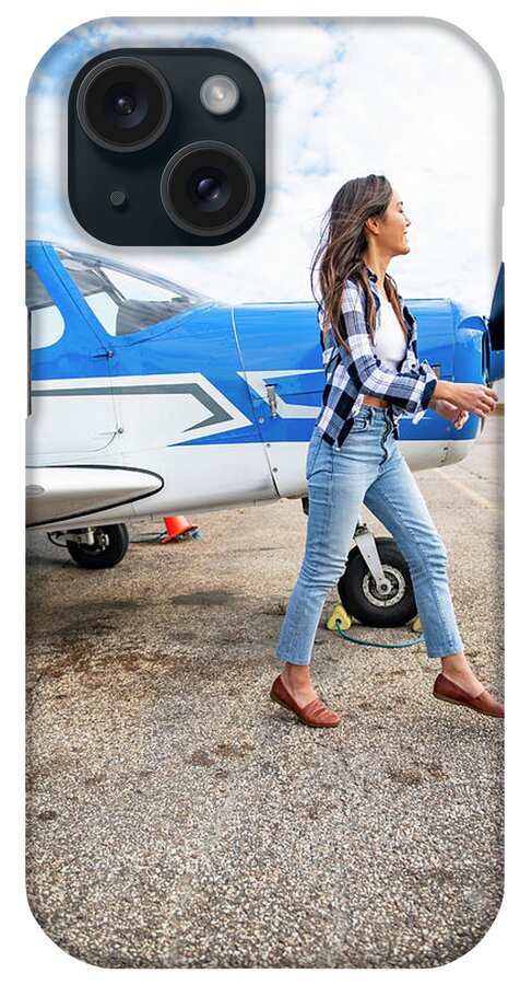 Airplane iPhone Case featuring the photograph Smiling Young Bipoc Female Pilot Walking By Front Of Small Airplane by Cavan Images / Cate Brown