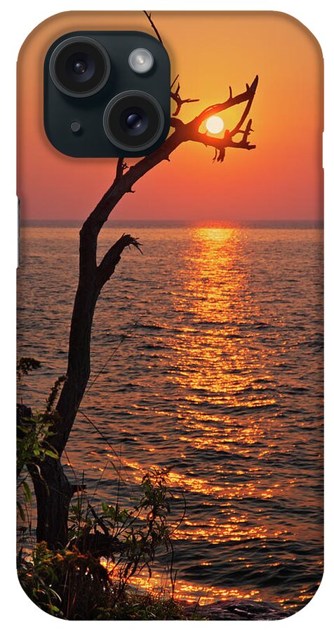 Sun Wi Cave Point Park Door County Lake Michigan Alignment iPhone Case featuring the photograph SunCatcher - Dead tree grasps the rising sun at Cave Point Park in Door County WI by Peter Herman