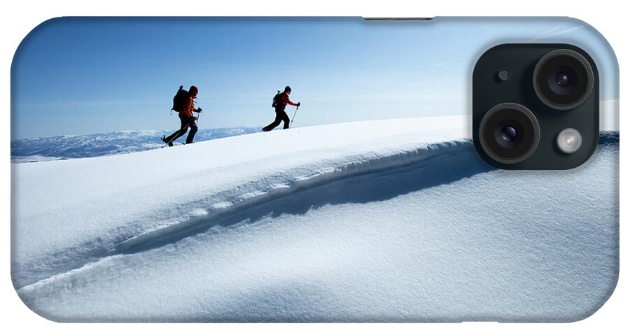 Young Men iPhone Case featuring the photograph Two Backcountry Skiers Hiking In Fresh by Trevor Clark